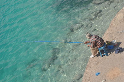 High angle view of man fishing at sea