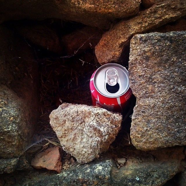 indoors, high angle view, still life, wall - building feature, old, rock - object, stone wall, close-up, no people, textured, brick wall, metal, day, stone - object, abandoned, wall, sunlight, stone, damaged