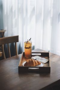 Food and drink in tray on table at home