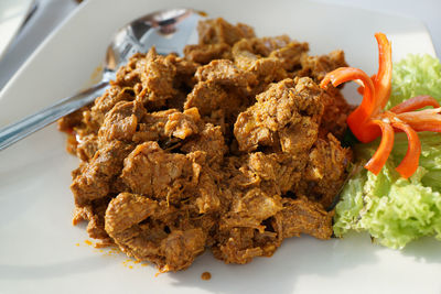 High angle close-up of beef rendang served in plate