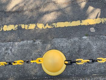 High angle view of yellow sign on road