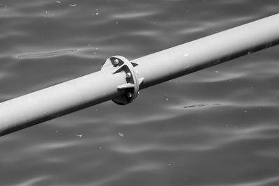 Close-up of metal pipe over water