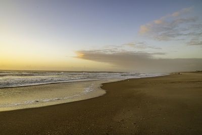 Scenic view of beach against sky during sunset