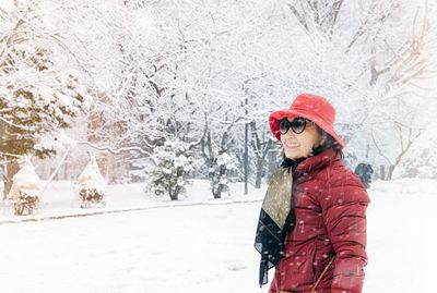 Smiling woman standing in snow