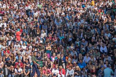 Crowd in stadium during sunny day