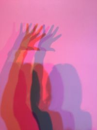 Shadow of people on pink wall