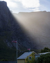 Houses on mountain against sky