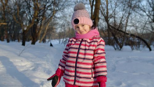 Midsection of child standing on snow covered land