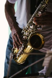 Midsection of man playing guitar