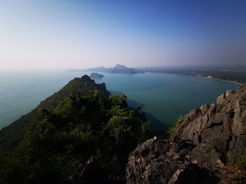 High angle view of rocks by sea against sky