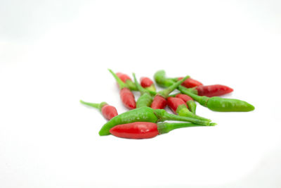 Close-up of red chili pepper against white background