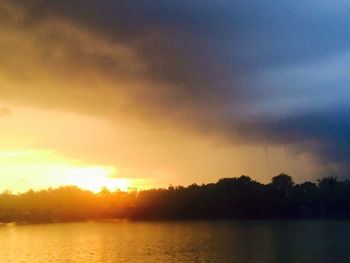 Scenic view of lake against sky during sunset