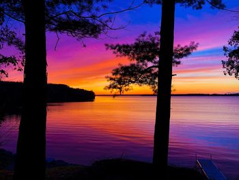 Scenic view of lake against romantic sky at sunset