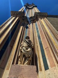 Low angle view of statue against building