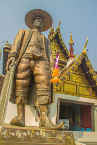 Low angle view of statue against building