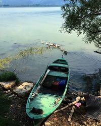 Boats moored on lake against sky