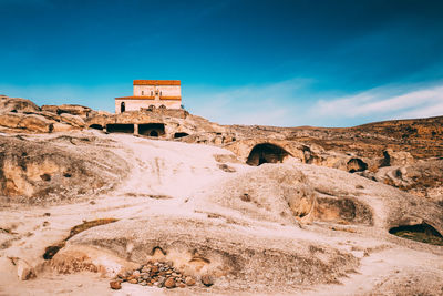 View of rock formation against blue sky