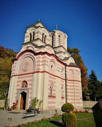 Low angle view of church against clear blue sky