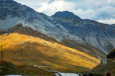 Scenic view of snowcapped mountains against cloudy sky