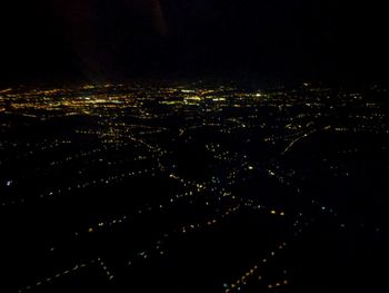 High angle view of illuminated buildings in city at night