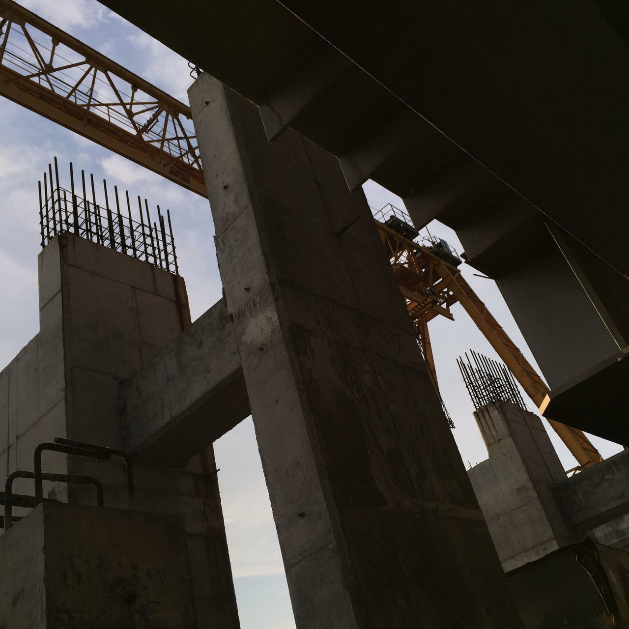 low angle view, built structure, architecture, building exterior, sky, old, history, outdoors, connection, day, no people, abandoned, metal, damaged, cloud - sky, engineering, city, run-down, travel destinations, building