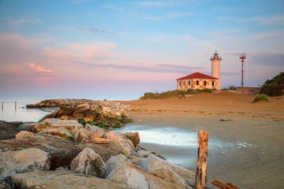 Scenic view of beach against sky during sunset