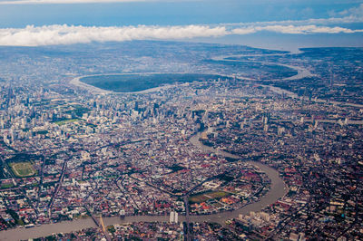 High angle view of townscape by sea against sky