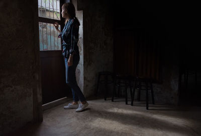 Woman standing in abandoned house