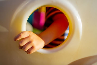 Cropped hand of person holding steering wheel