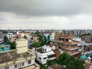 Cityscape against cloudy sky