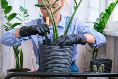 Man working on potted plant