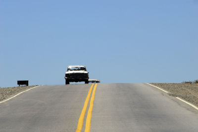 Lifeguard hut on road against clear sky