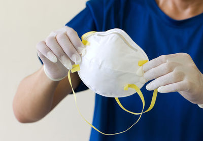 Midsection of man working against blue wall