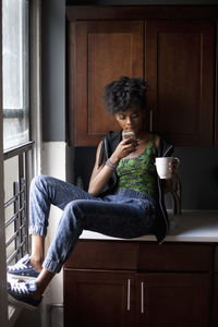 Woman sitting on seat at home