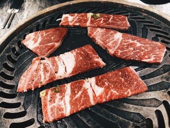 High angle view of meat on barbecue grill