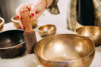 Woman playing tibetan singing bowl in sound healing therapy