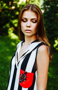 Fashionable young woman standing at public park