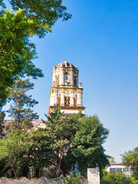 Low angle view of historical building against clear blue sky