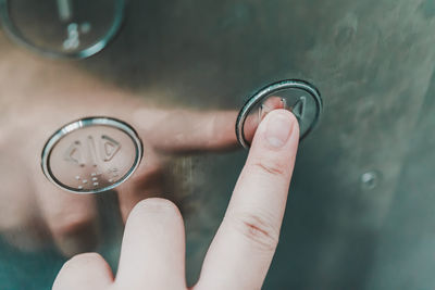 Close-up of hand holding glass against blurred background