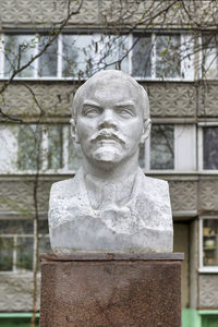 Close-up of statue against stone wall