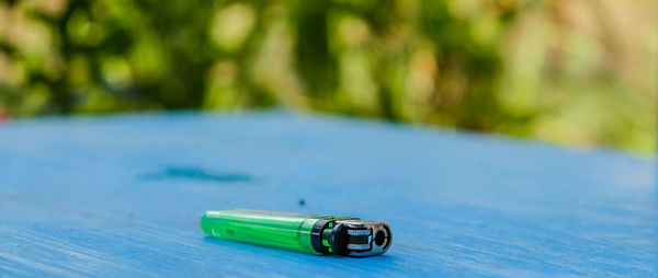 Close-up of cigarette lighter on table