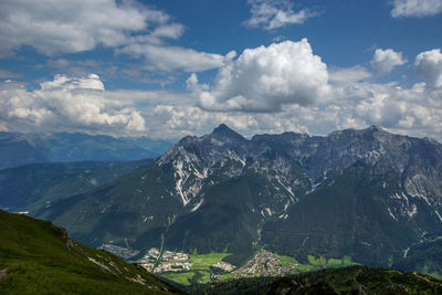 Aerial view of snowcapped mountain against cloudy sky