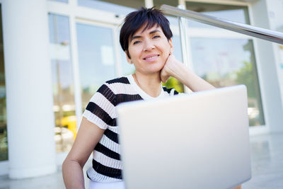 Young woman using laptop at home