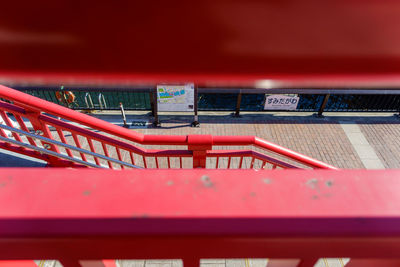Close-up of railing against red wall