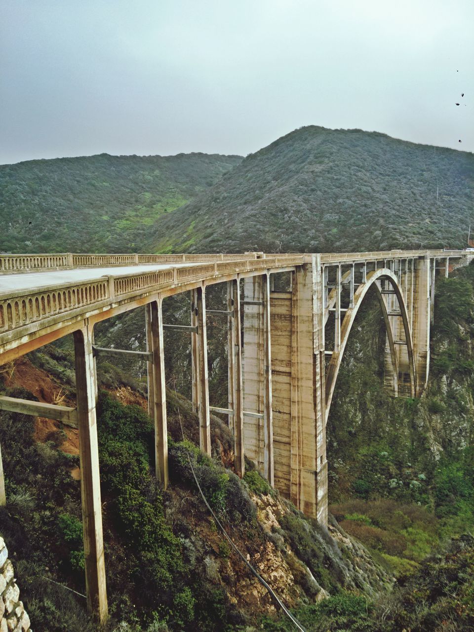 built structure, architecture, connection, bridge - man made structure, mountain, bridge, railing, sky, tranquility, nature, landscape, day, engineering, tranquil scene, water, river, outdoors, no people, tree, footbridge