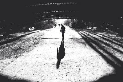 Full length of woman walking in tunnel