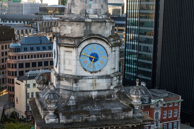 Clock tower amidst buildings in city