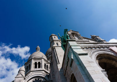 Low angle view of sacre coeur against blue sky