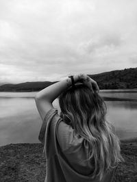 Rear view of woman looking at sea against sky
