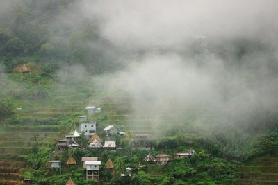 Aerial view of houses on landscape against sky